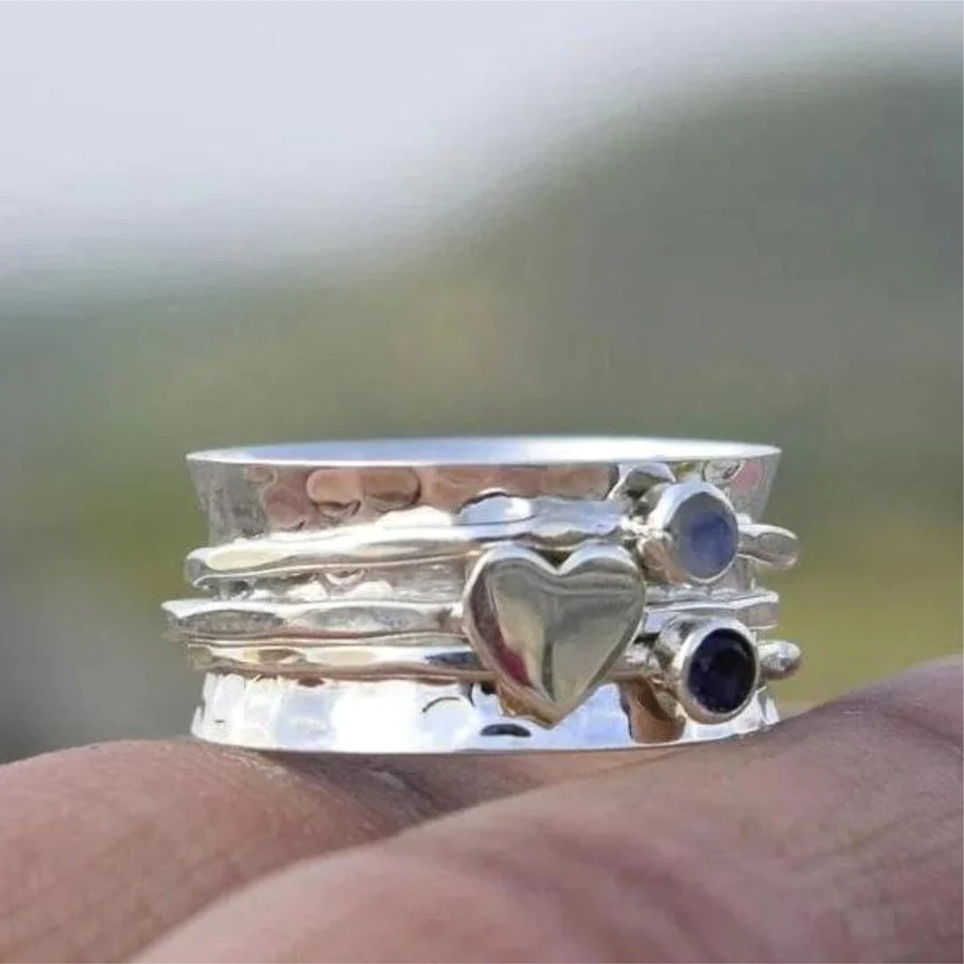 Anillo elegante en forma de corazón giratorio de plata esterlina